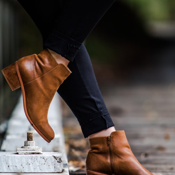 Tan ankle boots worn with black trousers