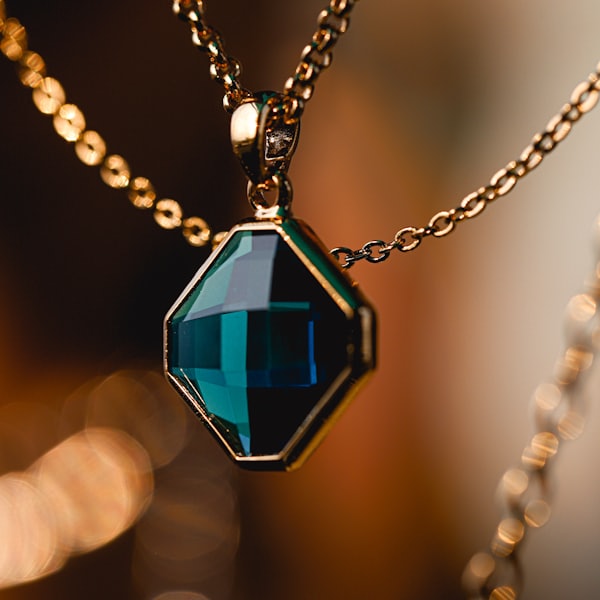 Teal gemstone pendant on a gold chain